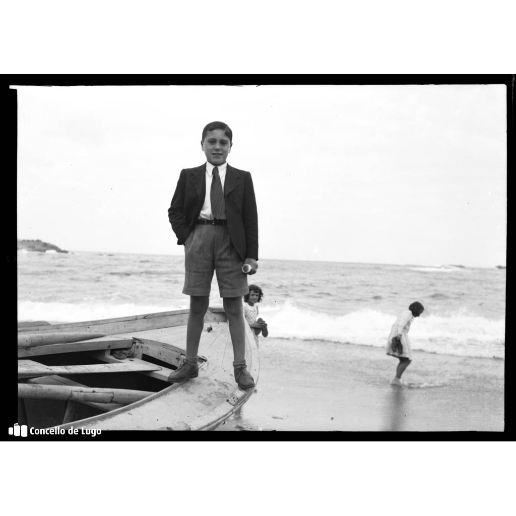 Retrato de Valentín Roldán nunha lancha na praia